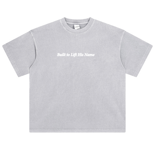 Gray Levage Shirt with text 'Built to Lift His Name' on the front with a white background