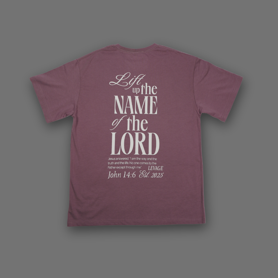 Levage English Lavender colored crewneck short-sleeved shirt displaying the saying Lift up the name of the Lord, with the quote of verse John 14:6. Also Levage Est. 2025