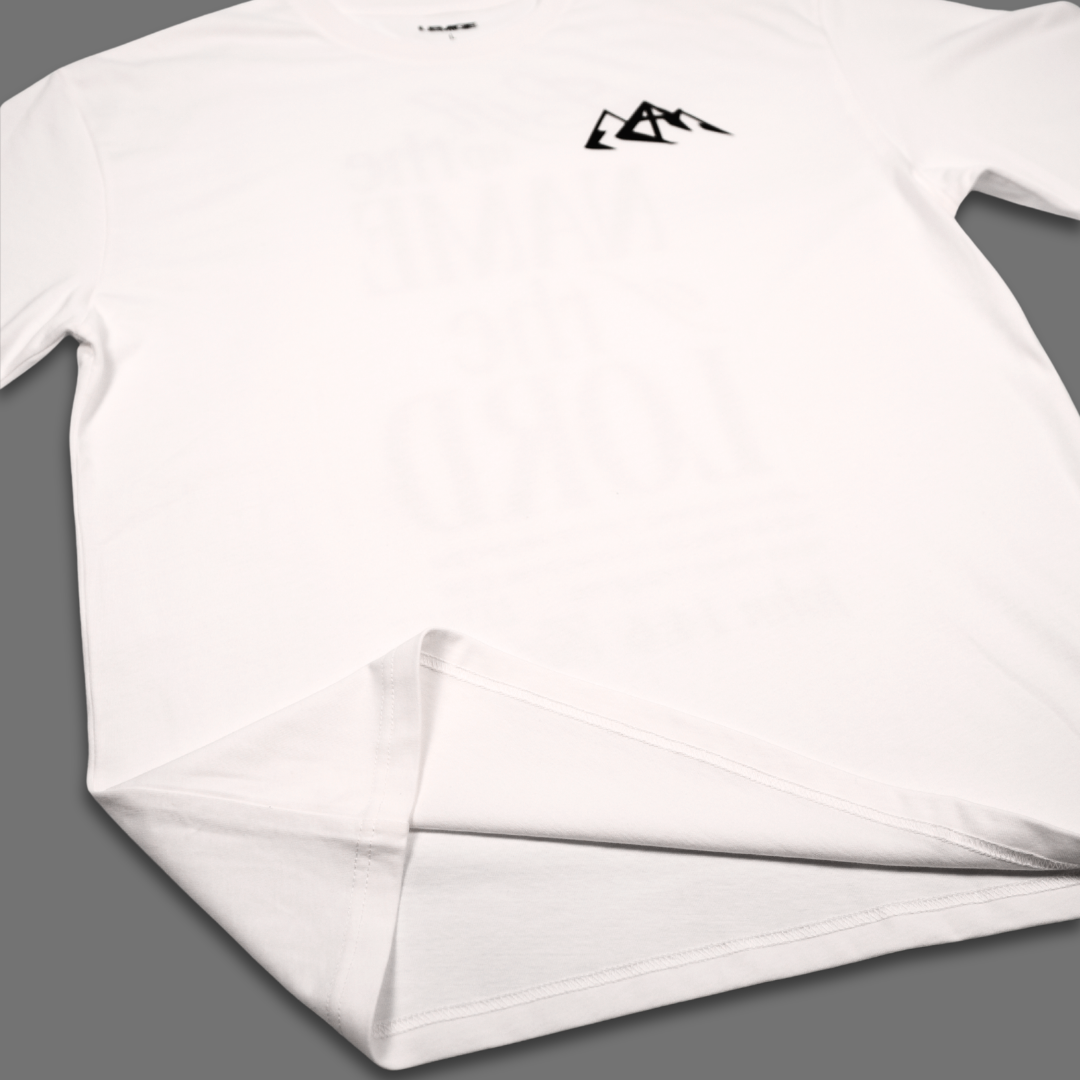A white short-sleeve t-shirt with a small black mountain logo on the left chest, laid flat on a solid gray background.